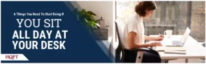Woman sitting at desk with a computer and notepad